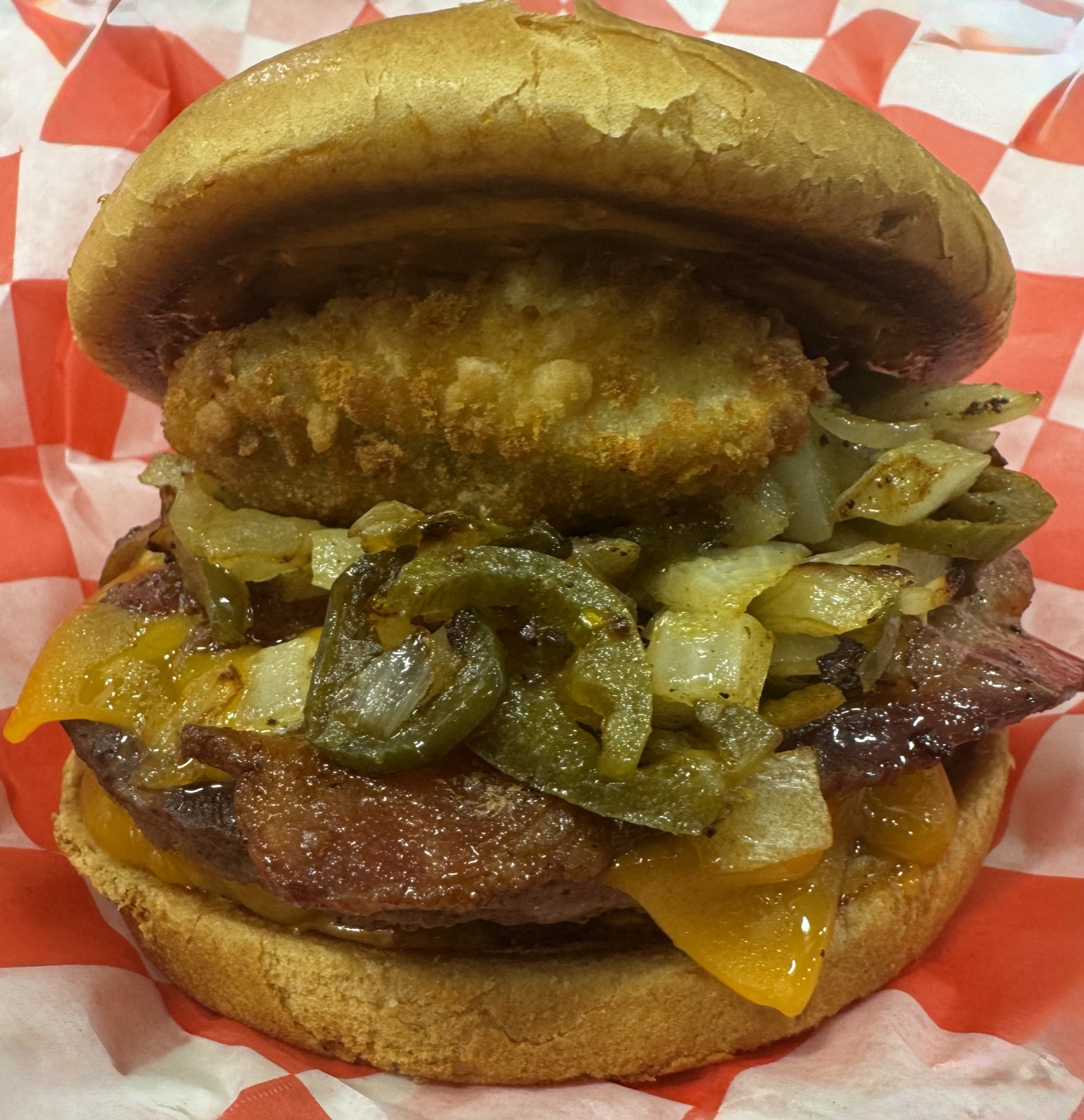 Jalapeño bacon cheddar burger topped with a fried jalapeño popper