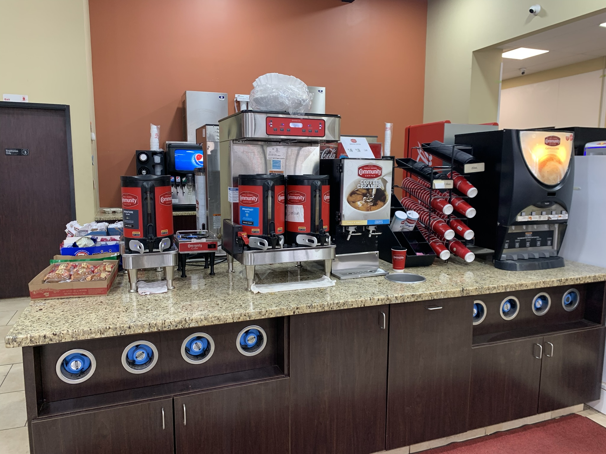 Community Coffee station with brewers and a cappuccino machine