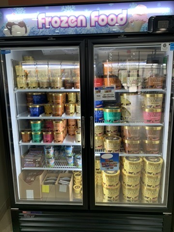 Frozen food freezer stocked with ice cream