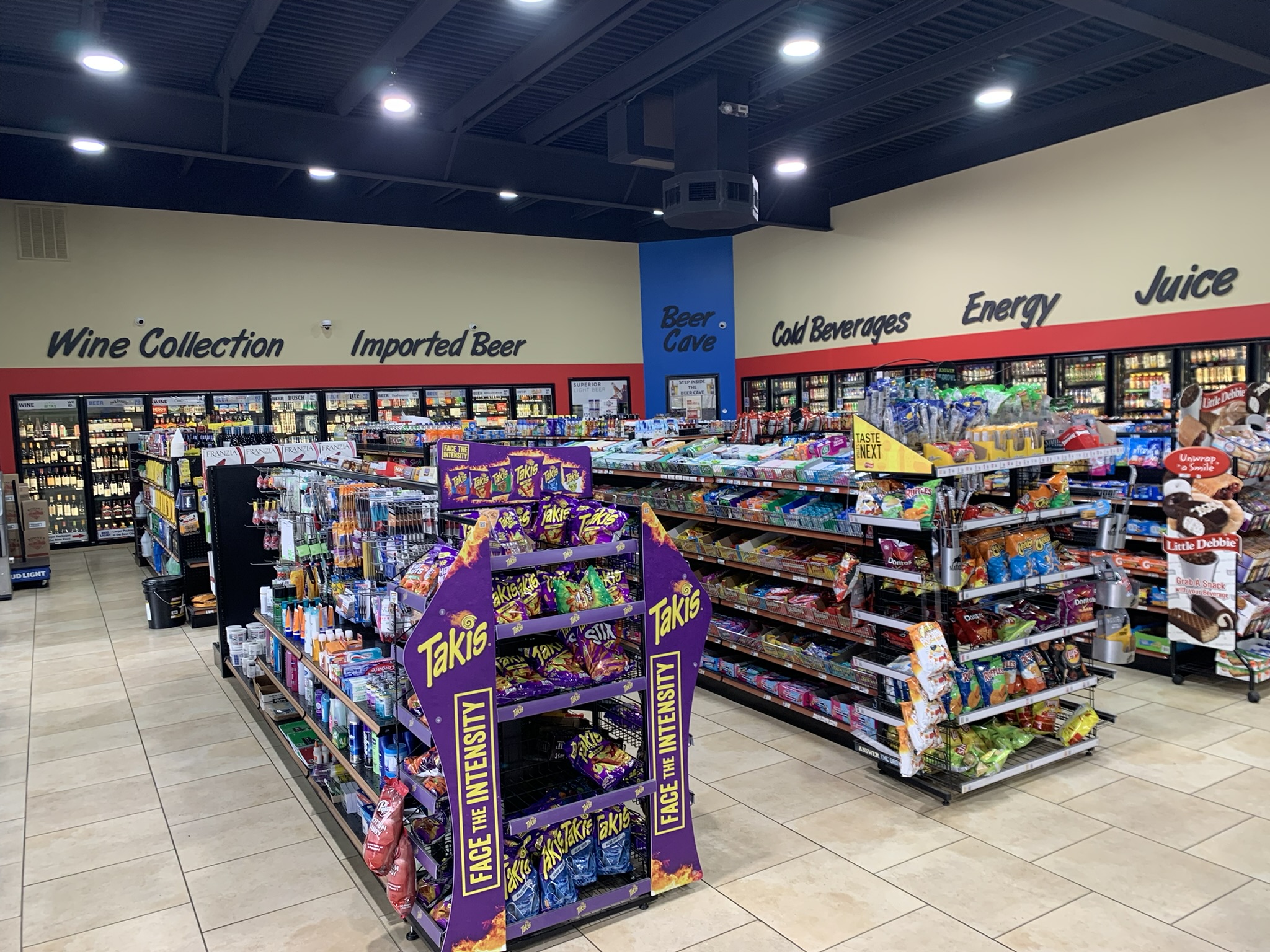 Store aisles with snacks and coolers of cold beverages